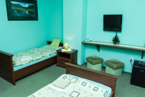 מיטה או מיטות בחדר ב-Pension Korona