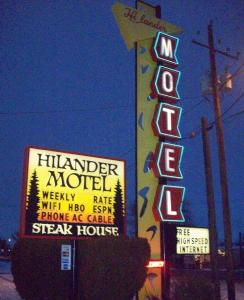 a neon sign with a neon sign on top of it at Hilander Motel in Mountain Home