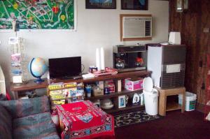a living room with a couch and a refrigerator at Hilander Motel in Mountain Home