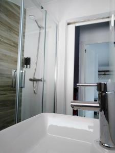 a bathroom with a sink and a shower at Casa Rural Teresa in El Molar