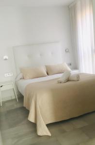 A bed or beds in a room at Domus Apartamentos Granada con parking gratuito en pleno centro