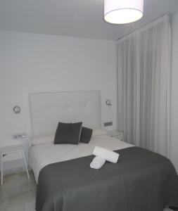 A bed or beds in a room at Domus Apartamentos Granada con parking gratuito en pleno centro