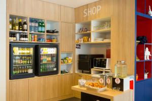 a kitchen with a refrigerator and a counter top at Aparthotel Adagio Basel City in Basel