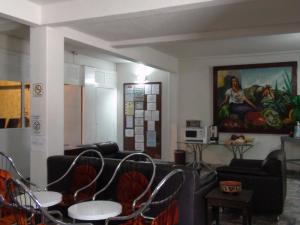 a waiting room with chairs and a painting on the wall at Hotel Panuco in Mexico City