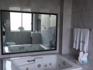 a bathroom with a tub and a large mirror at Hotel Panuco in Mexico City +24 photos