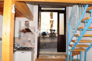 a kitchen with a staircase leading to a kitchen with a stair case at Stella Marina in Gaeta
