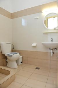 a bathroom with a toilet and a sink at Despoina in Skiathos