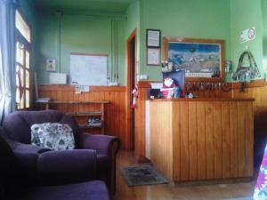 a waiting room with two chairs and a counter at Hostal El Rincón in Puerto Natales