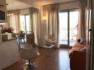 a living room with a couch and a table with chairs at LOFT 360° Nice in Nice