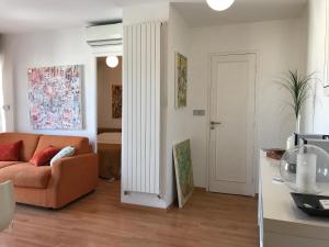 a living room with an orange couch and a white door at LOFT 360° Nice in Nice +42 photos
