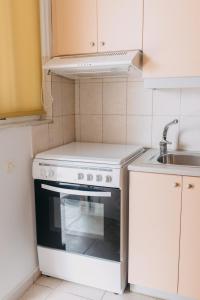 a kitchen with a white stove and a sink at Best House, Nirvana II, Patra in Patra