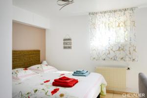 a bedroom with a bed with red towels on it at Aux Premières Loges in Fécamp