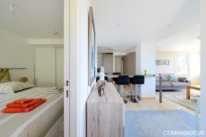 a bedroom with a bed and a living room at Aux Premières Loges in Fécamp