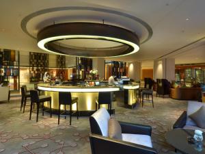 a hotel lobby with chairs and a large chandelier at Pullman Dongguan Changan in Dongguan