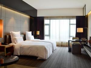 Voodi või voodid majutusasutuse Pullman Dongguan Changan toas
