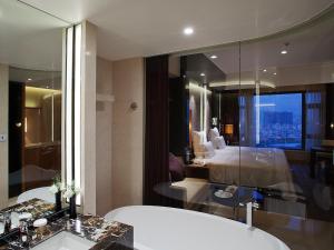 Voodi või voodid majutusasutuse Pullman Dongguan Changan toas