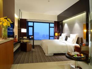 Voodi või voodid majutusasutuse Pullman Dongguan Changan toas