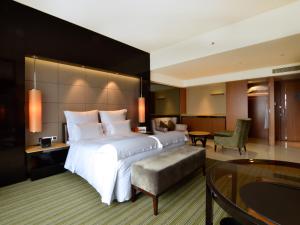 Voodi või voodid majutusasutuse Pullman Dongguan Changan toas