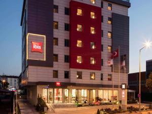 a lit up building with a bus sign on it at Ibis Istanbul West in Istanbul