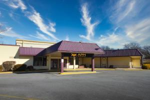 a building with a x star sign on the front at APM Inn & Suites in Martinsburg