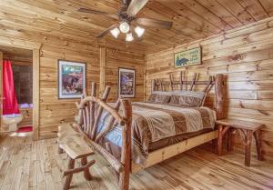 a bedroom with a bed in a log cabin at Heavenly Bear in Sevierville