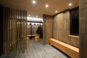 a hallway with wooden walls and benches in a room at Hiyoku 飛翼 in Niseko