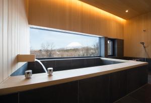 a bathroom with a sink and a large window at Hiyoku in Niseko