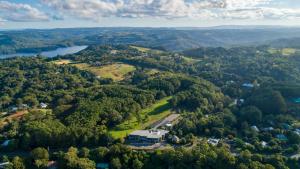 an aerial view of a forest with a building in the middle at Luxury Spa Retreat with Ocean and Hinterland Views in Montville