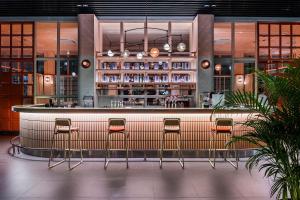 a bar in a restaurant with stools at Craftsman Bangkok in Bangkok