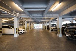 a large parking garage with cars parked in it at Craftsman Bangkok in Bangkok