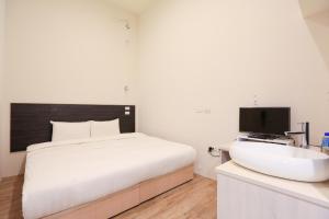 Postel nebo postele na pokoji v ubytování Place‧X Hotel