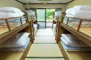 Postel nebo postele na pokoji v ubytování Showa Forest Village