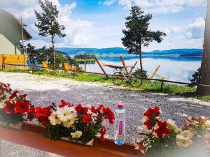 - une table avec des fleurs et une vue sur le lac dans l'établissement Villa Santa Maria, à Tsigov Chark