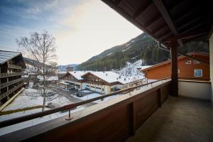 a balcony with a view of a snow covered mountain at Apartment Center in Saalbach-Hinterglemm