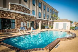 a large swimming pool in front of a building at Holiday Inn Express Hotel & Suites Houston NW Beltway 8-West Road by IHG in Houston