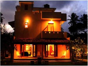 a large house with lights on top of it at Villa 61 in Beruwala