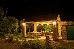 a pavilion with a table and chairs at night at Noosh Ashnak guesthouse in Ashnak