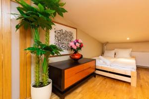 a bedroom with a bed and two potted plants at Apartment Warsaw City Center in Warsaw