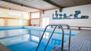 a large swimming pool with a staircase in it at Oberstdorfer Bergwelt 108 in Oberstdorf