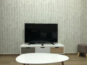 a flat screen tv sitting on top of a white table at M+V apartment in Alexandroupoli