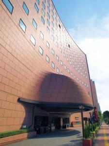 a large red brick building with a large entrance at Hotel Tokyo Garden Palace in Tokyo