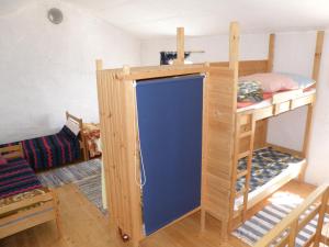 a room with two bunk beds and a blue door at Lošinj house robinson Vinodarska, Island Lošinj in Nerezine