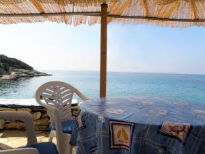 a table and chairs with a view of the ocean at Lošinj house robinson Vinodarska, Island Lošinj in Nerezine