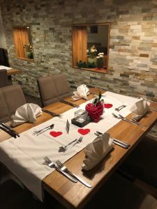 a table with a white table cloth with hearts on it at Württembergischer Hof in Kirchheim unter Teck