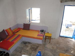 a room with a bed and a table and a window at Lošinj house robinson Vinodarska, Island Lošinj in Nerezine +12 photos
