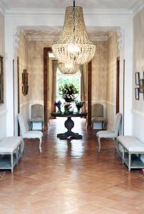 a large room with chairs and a chandelier at Château Ormes de Pez in Saint-Estèphe