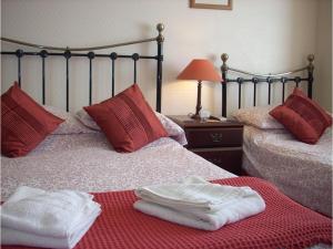 a hotel room with two beds with towels on them at The Adelphi in Paignton