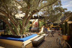 a patio area with tables, chairs and umbrellas at Bespoke Inn Scottsdale in Scottsdale