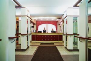 two men standing in a room with a mirror at Zolotoy Kolos in Moscow