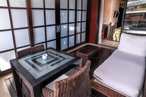 a table and chairs in a room with a table and a couch at Gran Hotel Guadalpín Banus in Marbella